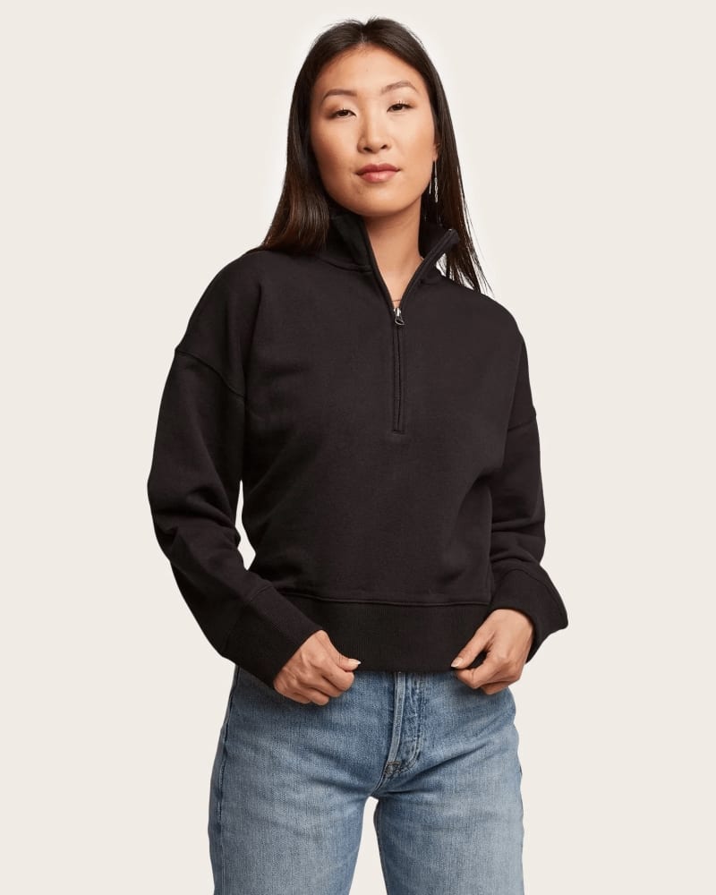Front of a model wearing a size 1X Cynthia Front Zip Sweatshirt in Black by ABLE. | dia_product_style_image_id:310238